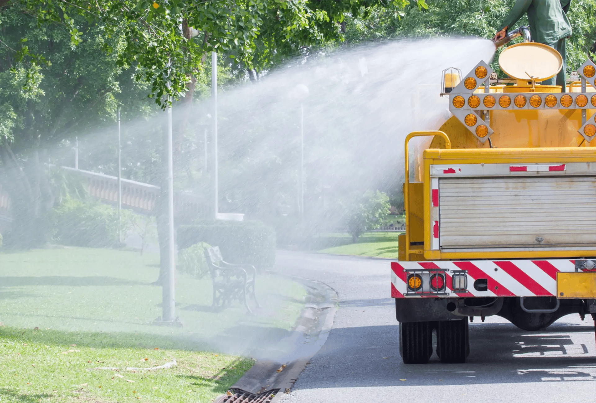 Watering truck spraying trees