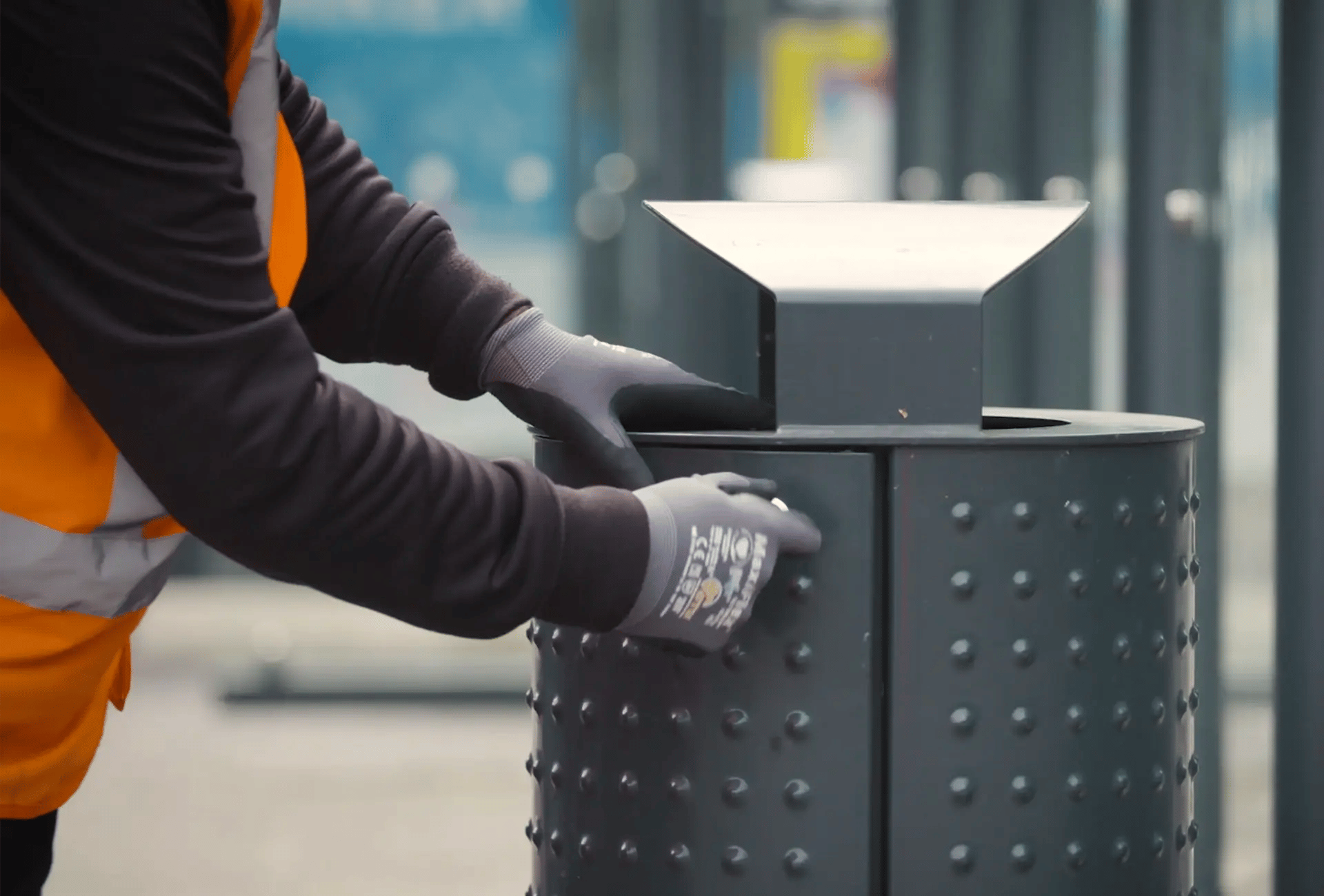Street cleansing worker emptying a waste bin