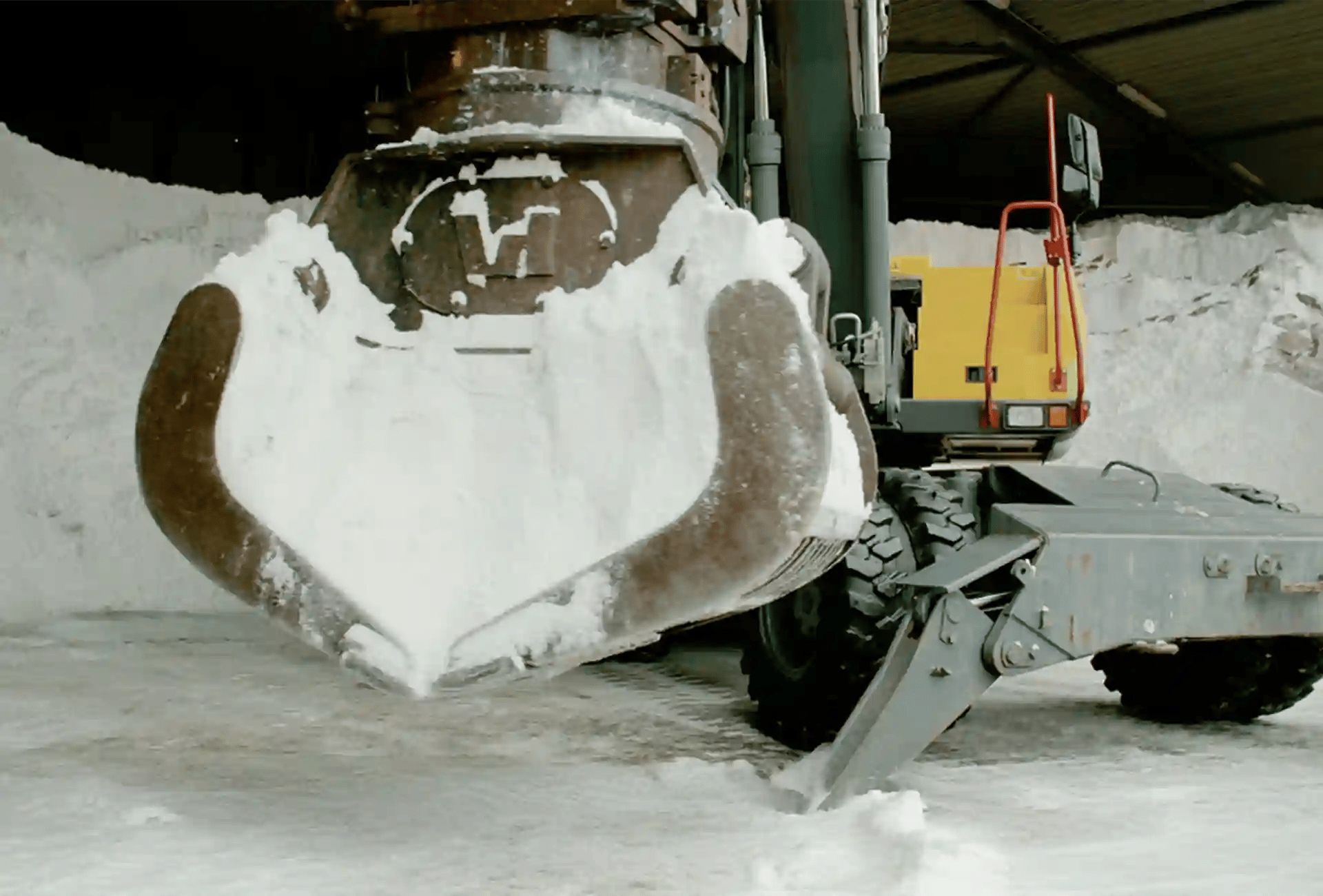 Crane picking up spreading salt
