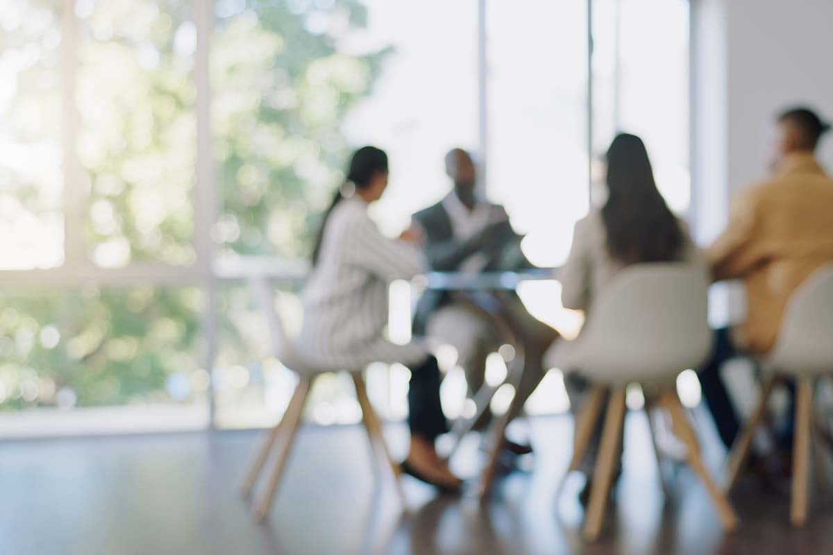 Blurred image of people working in office