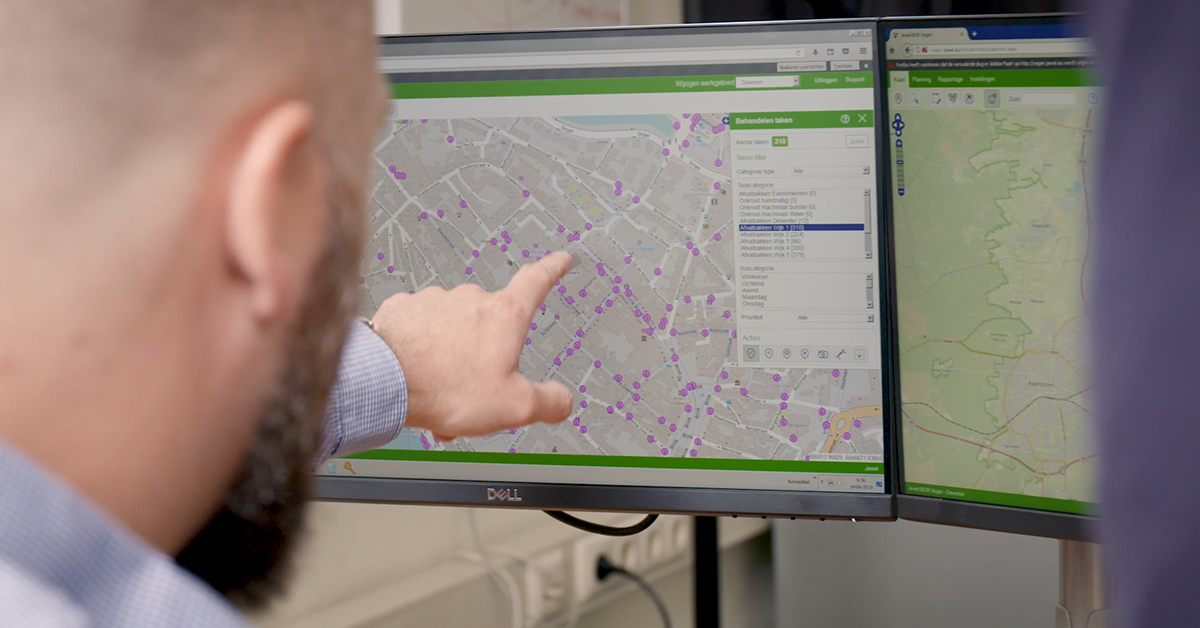 Municipal planner using Jewel software to monitor and assign public space maintenance tasks on a digital map