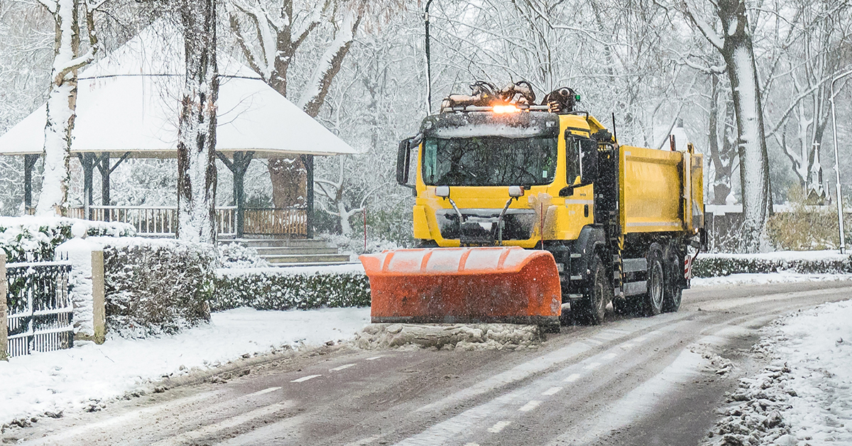 Municipal snow plow clearing streets after heavy snowfall